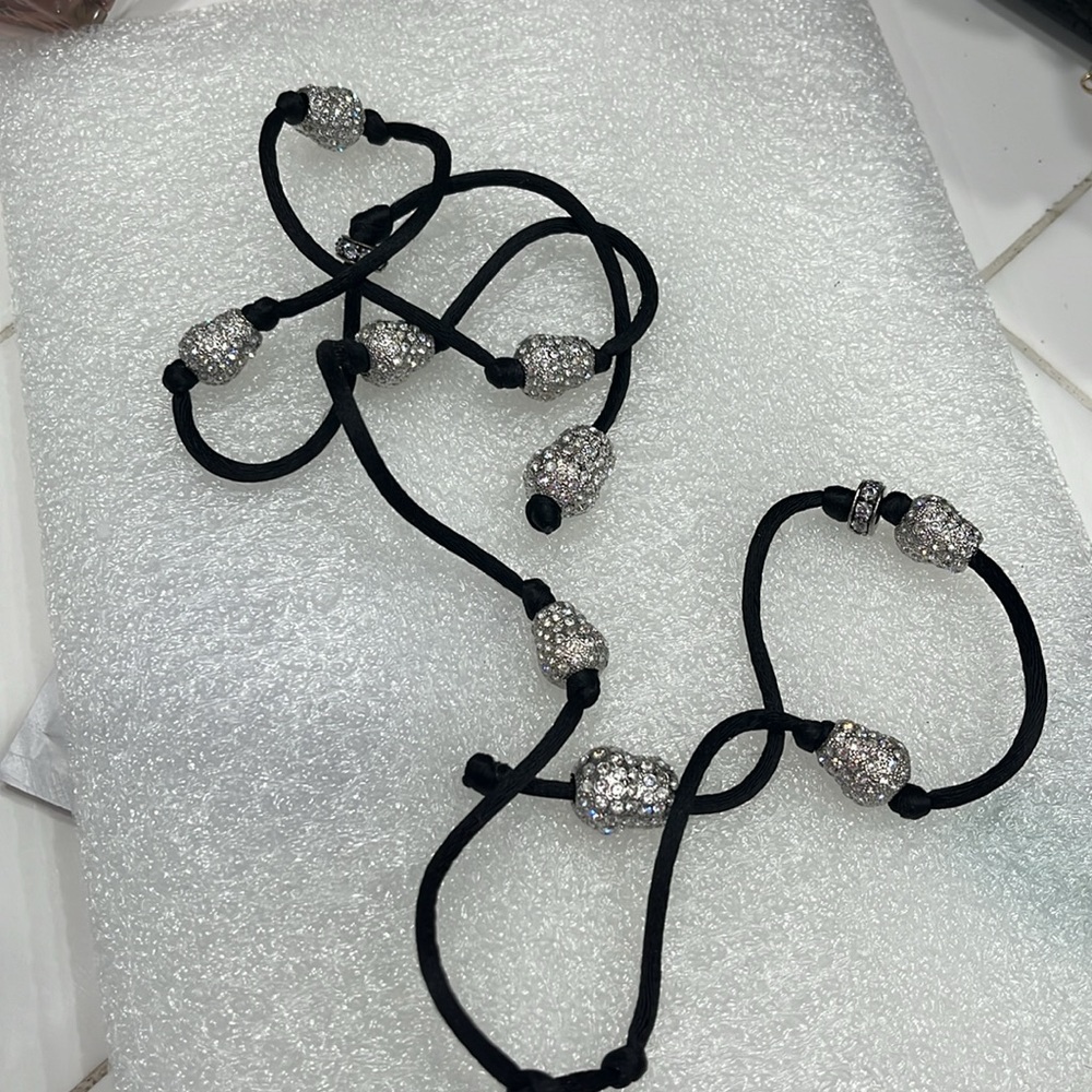 Pave lariat necklace on black silk rope